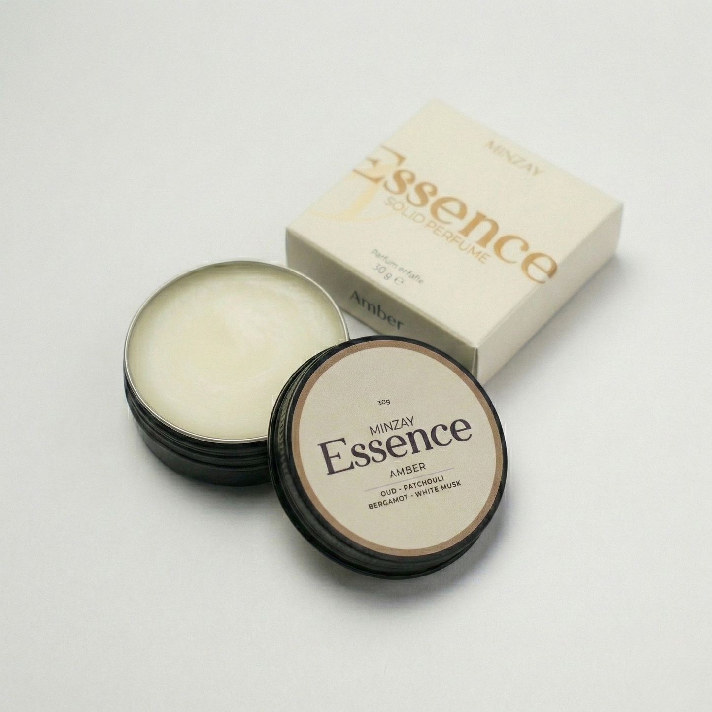 MINZAY Essence solid perfume in Amber, a deep, warm oud and patchouli blend, in a 30g tin