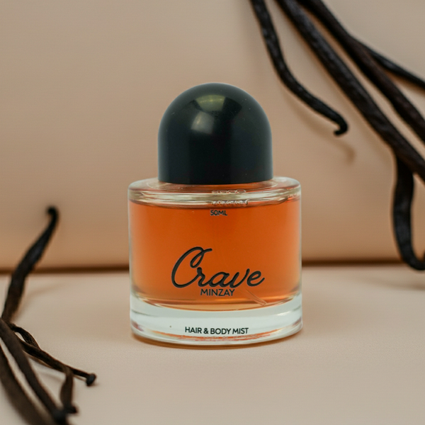 Hair and body mist bottle labeled 'Crave' with vanilla beans on a beige background
